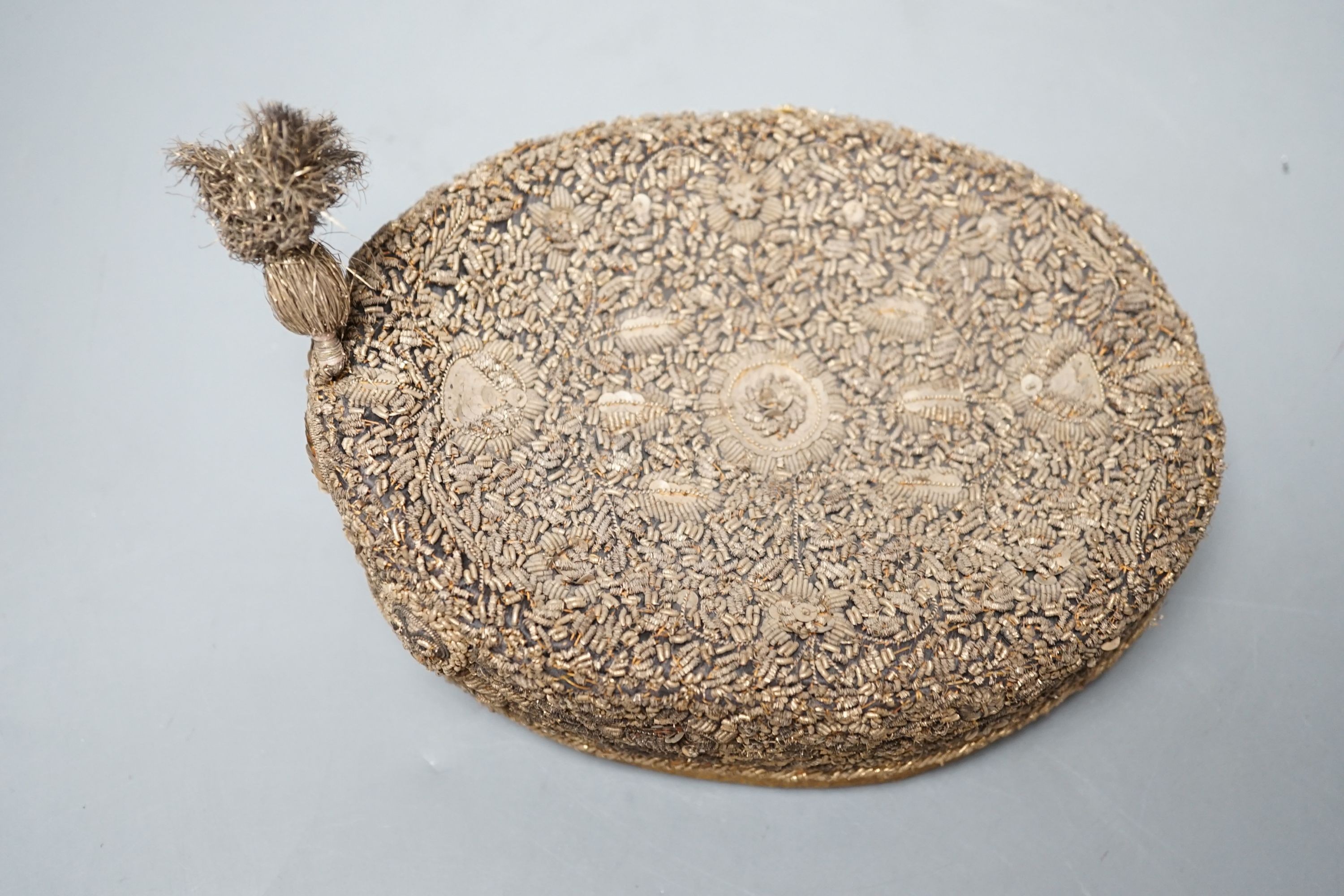 An Indian heavily embroidered cap with sequins and gilt thread 18cm